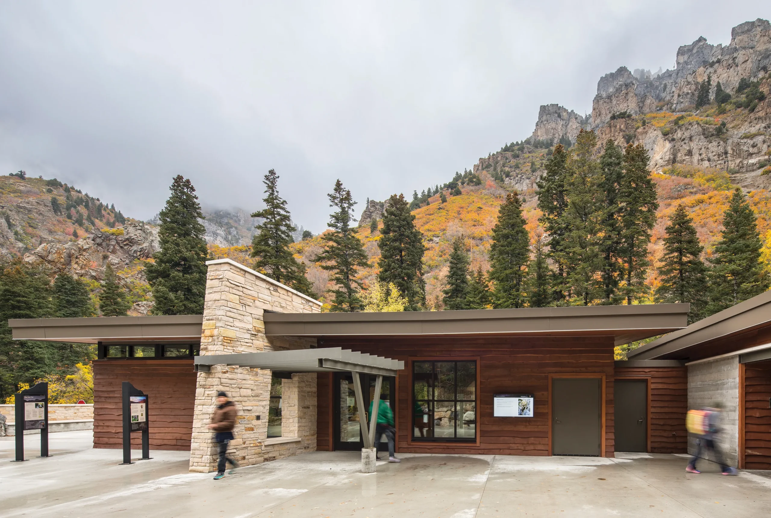 Visitor center entrance at Timpanogos Cave National Monument, featuring stone and wood materials that blend with the canyon landscape and an extended canopy for shelter.