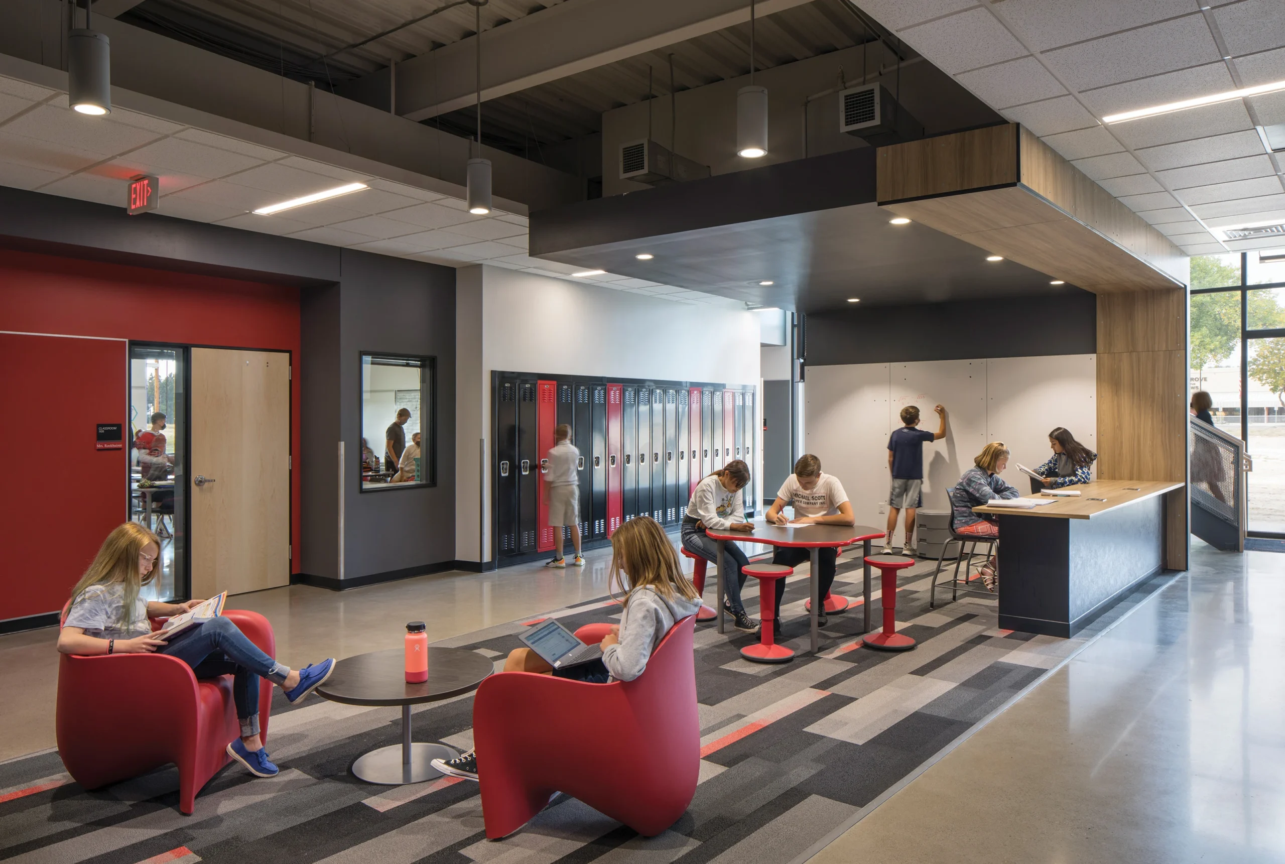 A flexible collaboration space at Elder Grove Middle School encourages student engagement with comfortable seating, interactive whiteboards, and group study areas.