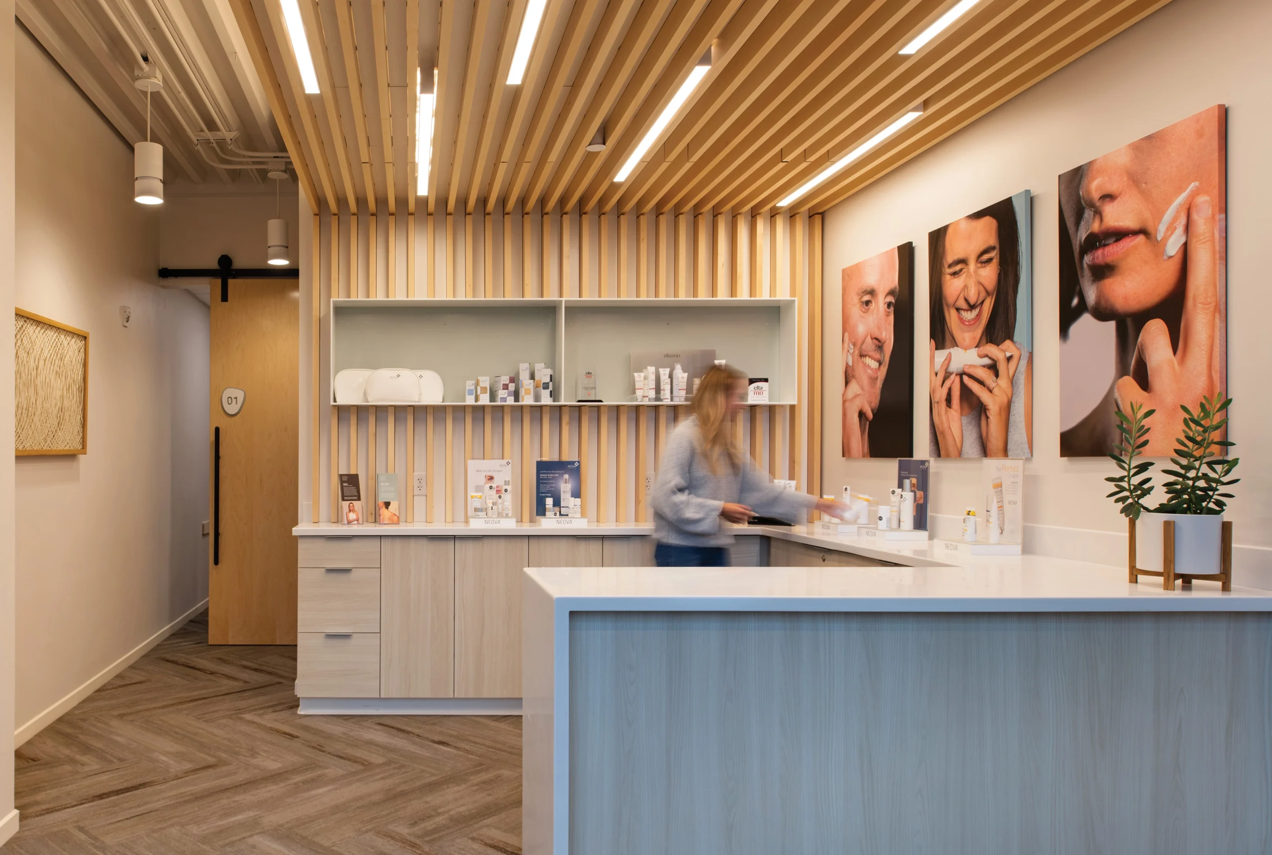 A modern skincare retail space featuring a sleek product display, warm wood detailing, and vibrant imagery that highlights self-care and skin wellness.