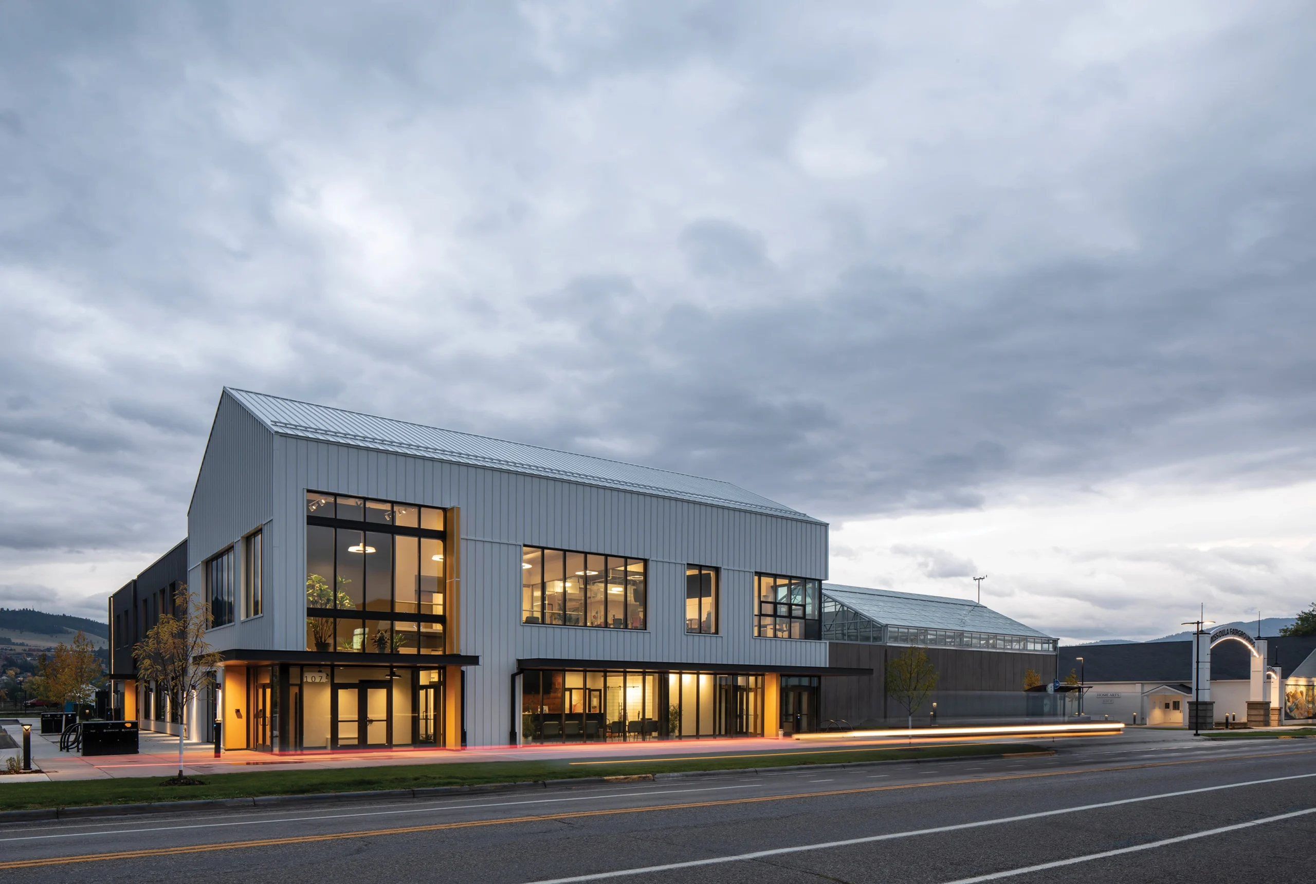 Exterior view of the Gerald W. Marks Exploration Center & Rocky Mountain Gardens, which features a modern facility and greenhouse.