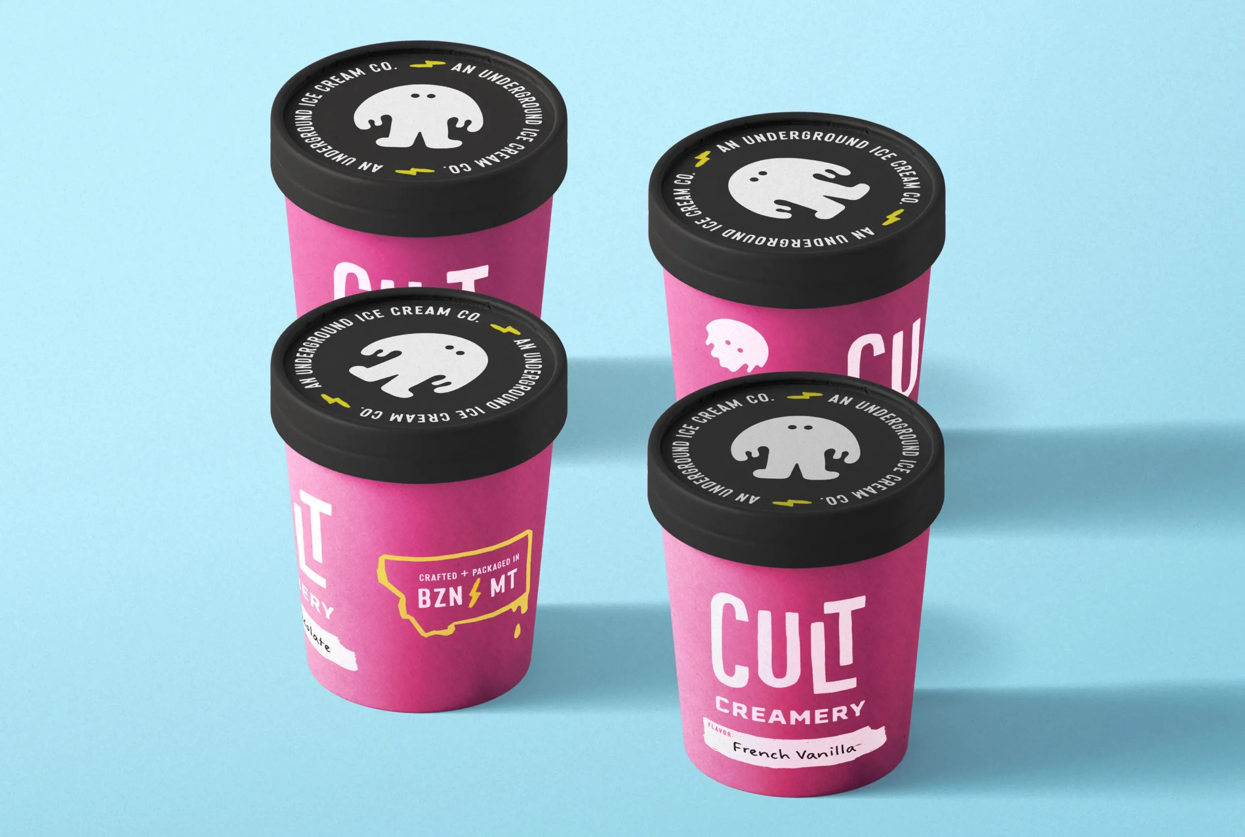 The Cult Creamery packaging design is bold and rebellious, featuring vibrant pink pints with high-contrast black lids, playful typography, and an eye-catching ghost mascot that reinforces the brand’s underground appeal.